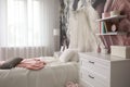 Teenage girl`s room interior with bed, chest of drawers and floral wallpaper. Idea for stylish design Royalty Free Stock Photo