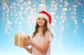 Teenage girl in santa hat with christmas gift Royalty Free Stock Photo