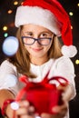 Teenage girl with Santa hat holding a present Royalty Free Stock Photo