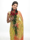 Teenage girl in sari holding red roses Royalty Free Stock Photo