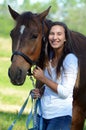 A teen girl laughs with her horse Royalty Free Stock Photo