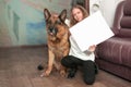 Teenage girl showing her drawing depicting her dog Royalty Free Stock Photo