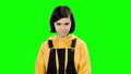 Teenage girl shows a heart shape. Green screen