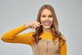 Teenage girl shows teeth through magnifying glass Royalty Free Stock Photo