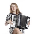 Teenage girl sits in studio with accordion Royalty Free Stock Photo