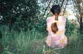 A teenage girl is sitting back on the grass alone Royalty Free Stock Photo