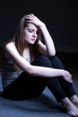 Teenage girl sitting on floor Royalty Free Stock Photo