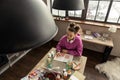 Teenage girl sitting in kitchen and writing composition