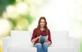 Teenage girl sitting on sofa with tablet pc Royalty Free Stock Photo