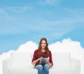 Teenage girl sitting on sofa with tablet pc Royalty Free Stock Photo