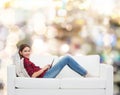 Teenage girl sitting on sofa with tablet pc Royalty Free Stock Photo