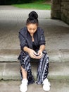 Portrait of a African American girl sitting on steps outide in Cleveland, Ohio