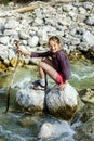 Teenage girl sitting on stone Royalty Free Stock Photo