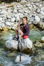 Teenage girl sitting on stone Royalty Free Stock Photo