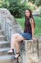 Teenage girl sitting on wall Royalty Free Stock Photo