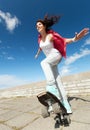 Teenage girl skating outside