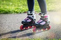 Teenage girl is skating on roller blades in the park Royalty Free Stock Photo