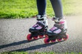 Teenage girl is skating on roller blades in the park Royalty Free Stock Photo