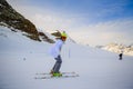 Teenage girl skiing in Swiss Alps in Sunny Day.