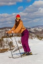 Teenage girl skis in the mountains