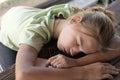 Teenage girl sleeping with head down on desk. Tired of learning