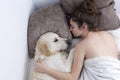 Teenage girl sleeping with her dog. Royalty Free Stock Photo