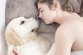 Teenage girl sleeping with her dog. Royalty Free Stock Photo