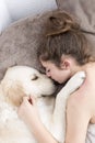 Teenage girl sleeping with her dog. Royalty Free Stock Photo