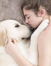 Teenage girl sleeping with her dog. Royalty Free Stock Photo