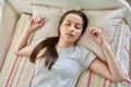 Teenage girl sleeping at home in bed, calm peaceful female teenager with closed eyes