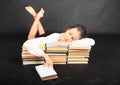 Teenage girl sleeping on old books
