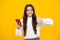 Teenage girl with smart phone. Portrait of teen child using mobile phone, cell web app. Happy face, positive and smiling Royalty Free Stock Photo