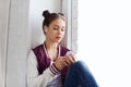 Teenage girl with smartphone and earphones