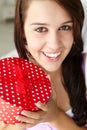 Teenage girl smiling and holding red gift box Royalty Free Stock Photo