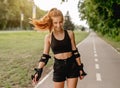 Teenage girl in sportswear roller skating Royalty Free Stock Photo
