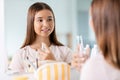 teenage girl spraying perfume at bathroom