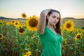 Teenage girl standing in a field of sunflowers Royalty Free Stock Photo