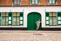 Teenage girl in front of a green door in Belgium