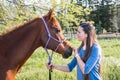 Teenage girl standing with her chestnut Arab horse Royalty Free Stock Photo