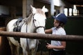 Teenage girl standing with horse Royalty Free Stock Photo