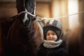 Teenage girl standing with horse in a stable Royalty Free Stock Photo