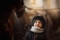 Teenage girl standing with horse in a stable Royalty Free Stock Photo
