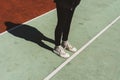 Teenage girl standing on rubberized sport ground