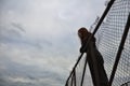 a teenage girl stands alone on the pier at the pier solitude trying isolation to cope with anger and find strength in