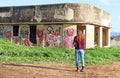 A teenage girl stands in front of a ruin house Royalty Free Stock Photo