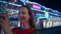 Teenage girl streaming smartphone video at funfair closeup. Excited blogger use Royalty Free Stock Photo