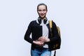 Teenage girl student with backpack holding laptop on white studio background Royalty Free Stock Photo