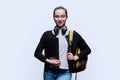 Teenage girl student with backpack holding laptop on white studio background Royalty Free Stock Photo