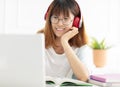 Teenage girl studying book at home