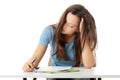 Teenage girl studying at the desk being tired Royalty Free Stock Photo